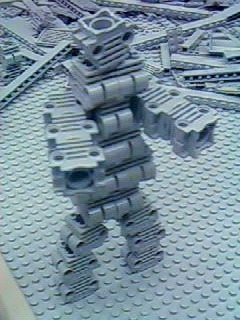 Robot-man built entirely from gray engine cylinders